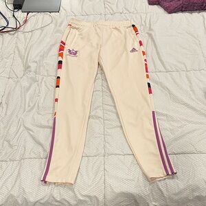 Adidas ladies Thebe Magugu Cream Joggers with Purple and Orange Stripes